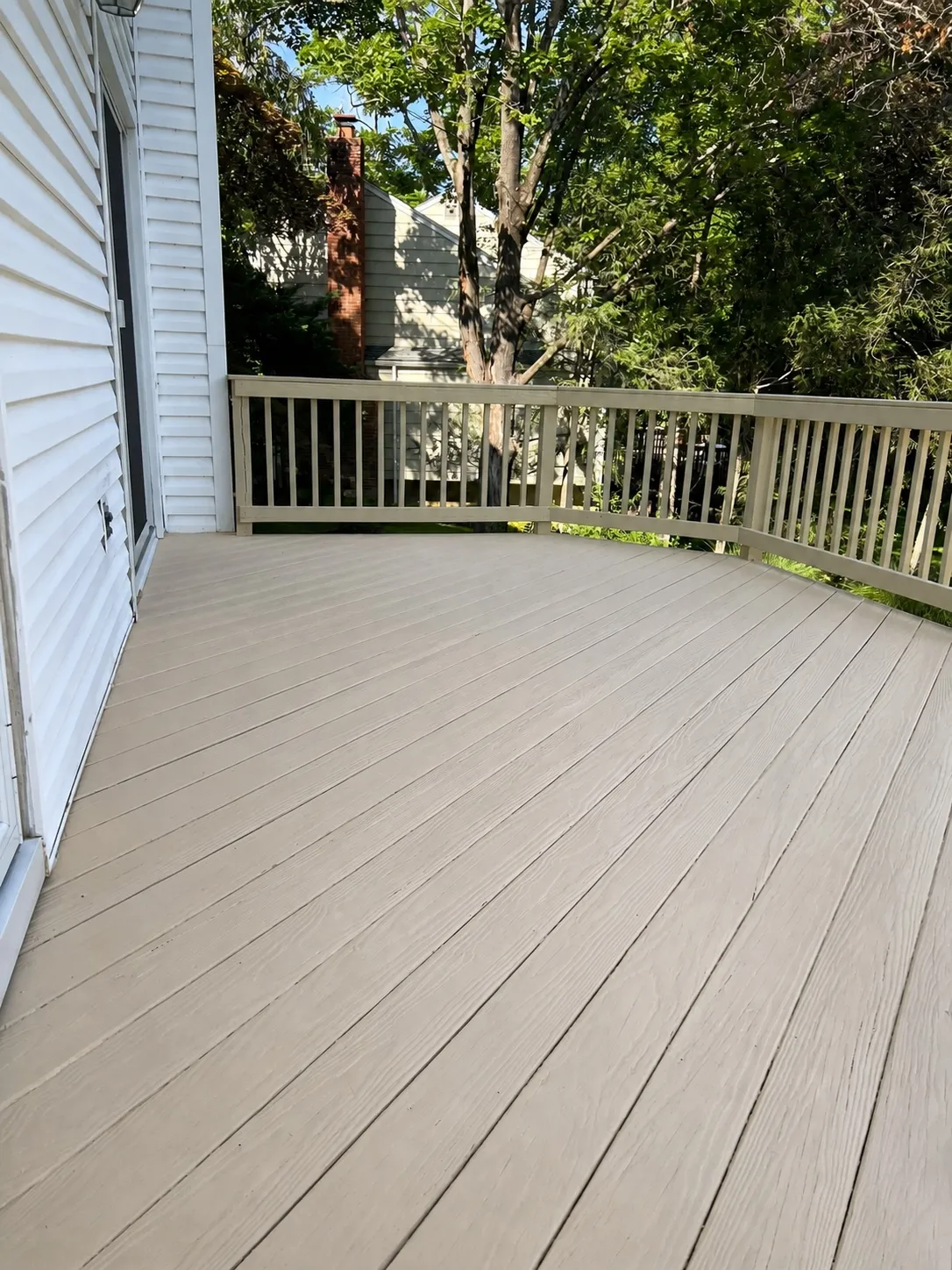 Refinished deck stairs and landing with consistent color by Genesis Pro Painting