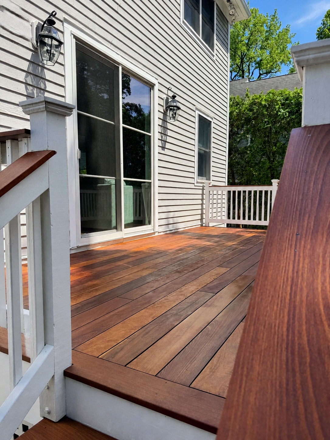 Weathered deck restored with a fresh protective finish by Genesis Pro Painting