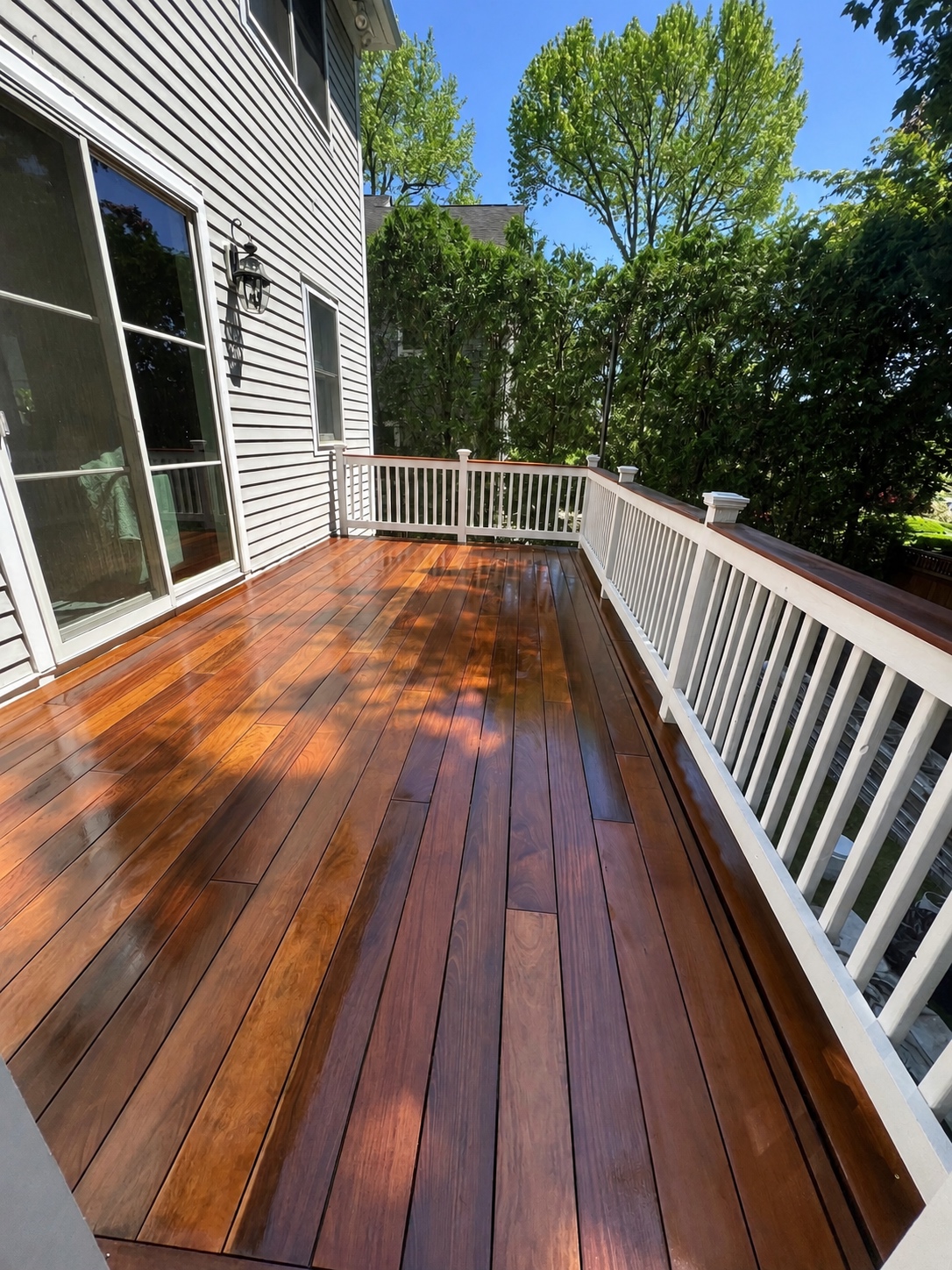 Refinished deck with even color on boards, stairs, and railings by Genesis Pro Painting in Westchester NY