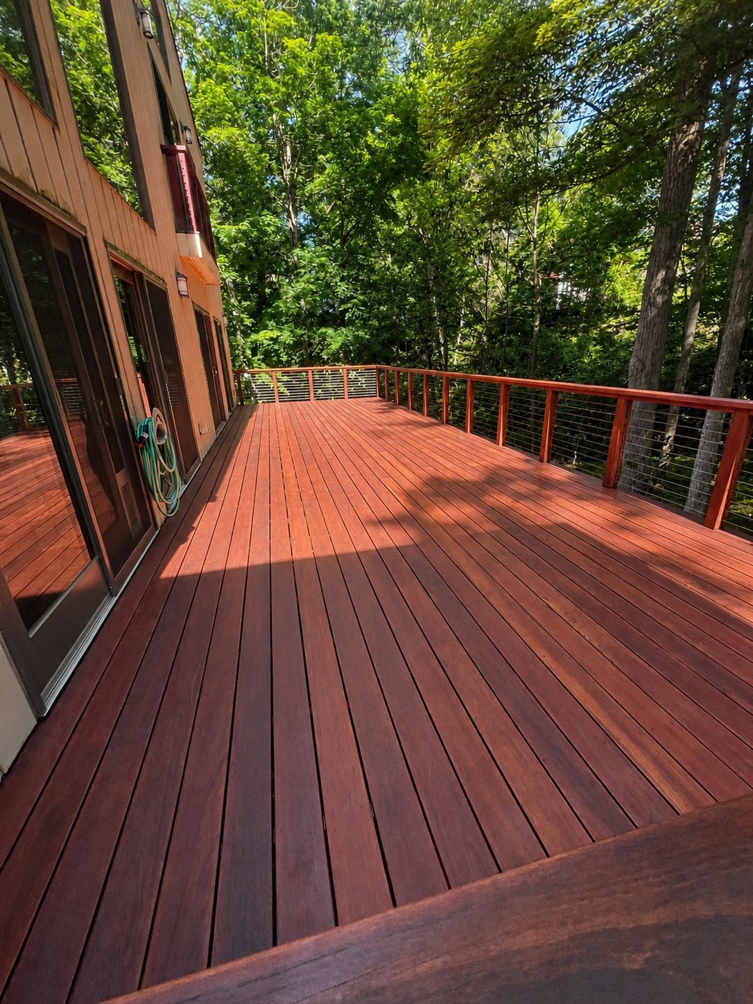 Outdoor wood structure with restored surfaces and finished trim by Genesis Pro Painting