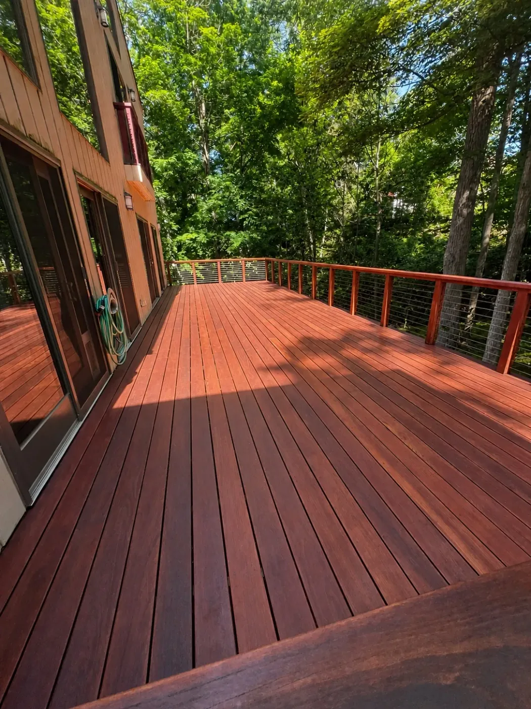 Outdoor wood structure with restored surfaces and finished trim by Genesis Pro Painting