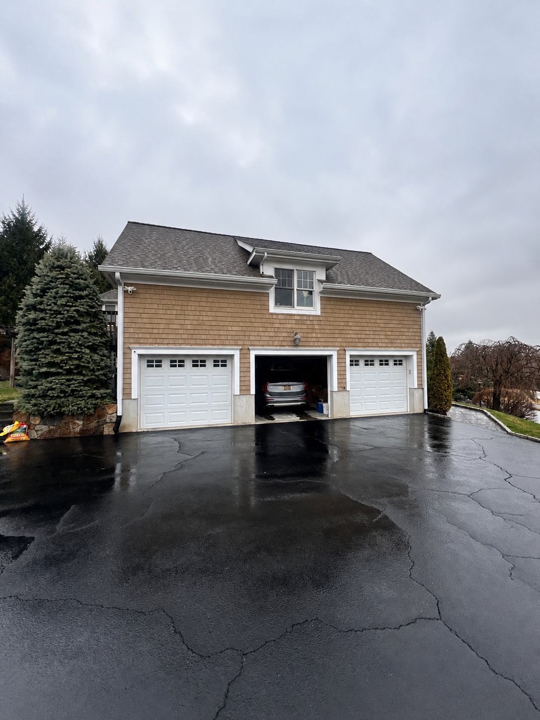 Pressure washed asphalt driveway and garage apron at a Westchester home by Genesis Pro Painting