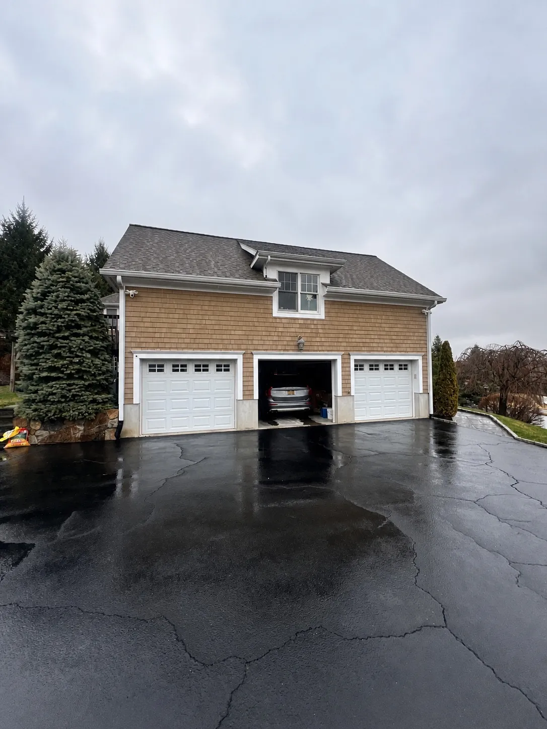 Pressure washed asphalt driveway and garage apron at a Westchester home by Genesis Pro Painting