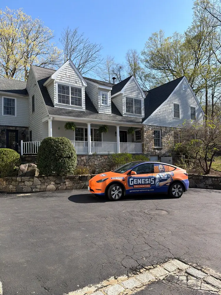 Genesis Pro Painting branded vehicle outside a shingle-sided home