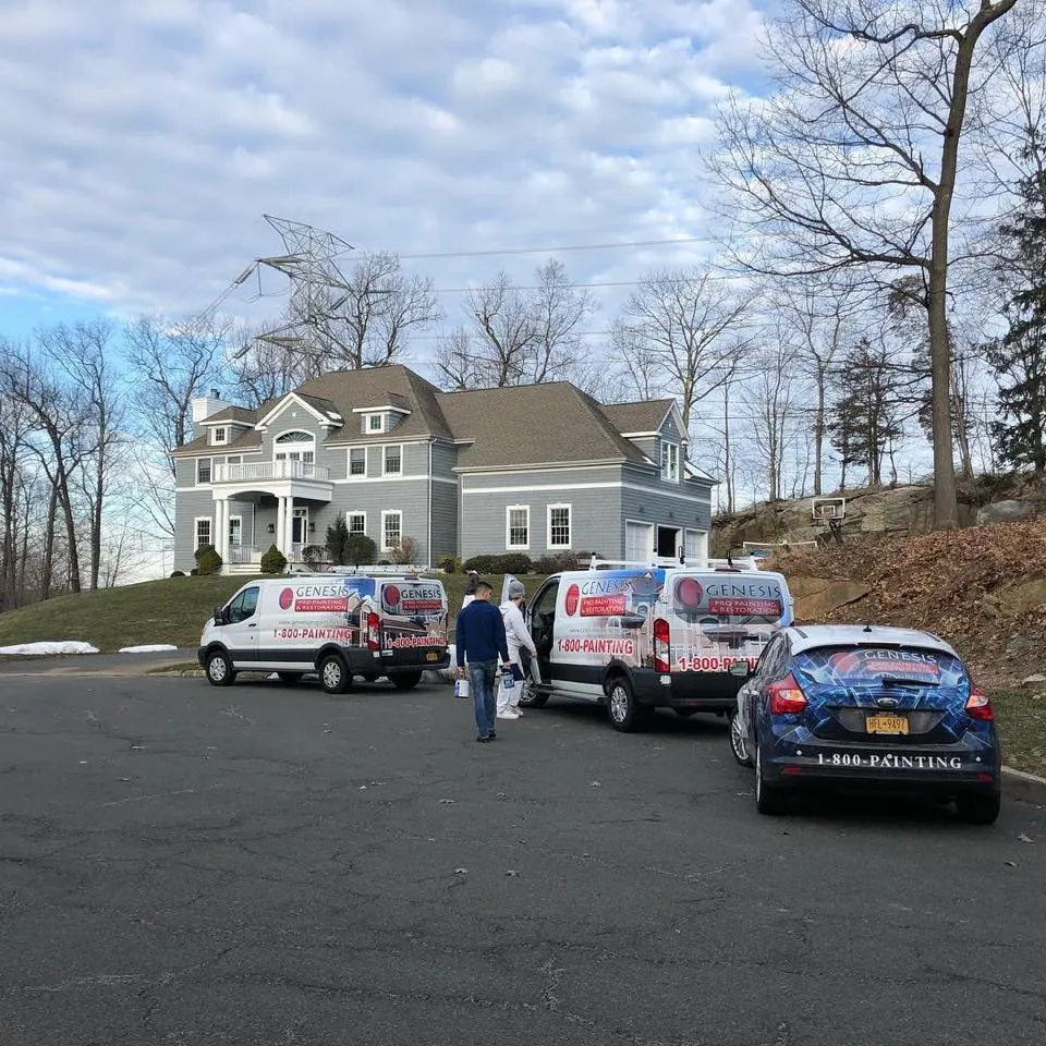 Genesis Pro Painting crew and vehicles outside a residential project