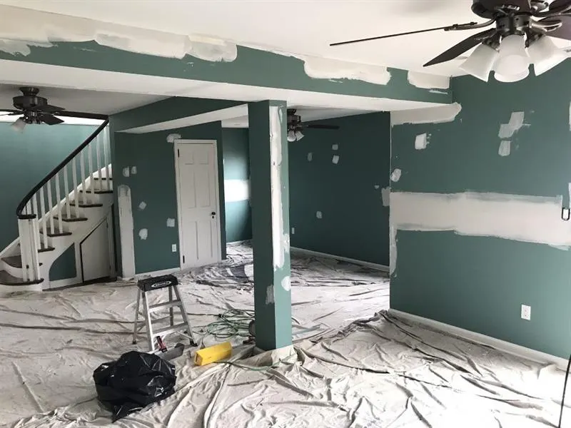 Patched drywall and protected floors during preparation for interior painting