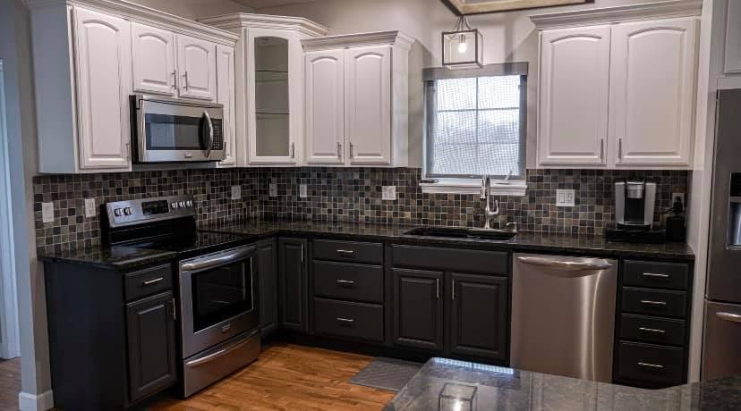 White upper and dark lower kitchen cabinets after refinishing in Katonah, NY by Genesis Pro Painting.