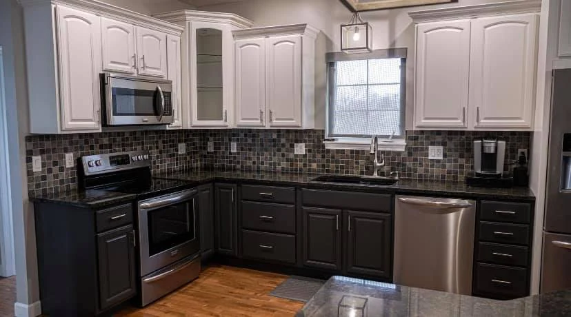White upper and dark lower kitchen cabinets after refinishing in Katonah, NY by Genesis Pro Painting.