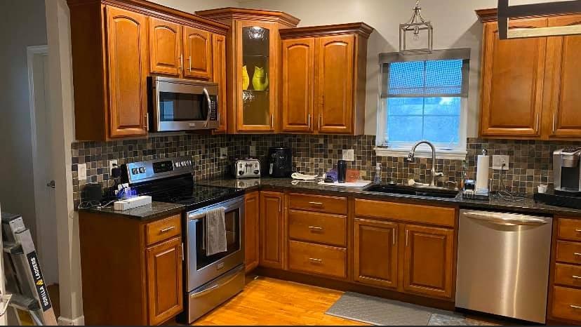 Stained wood kitchen cabinets before refinishing in Katonah, NY.