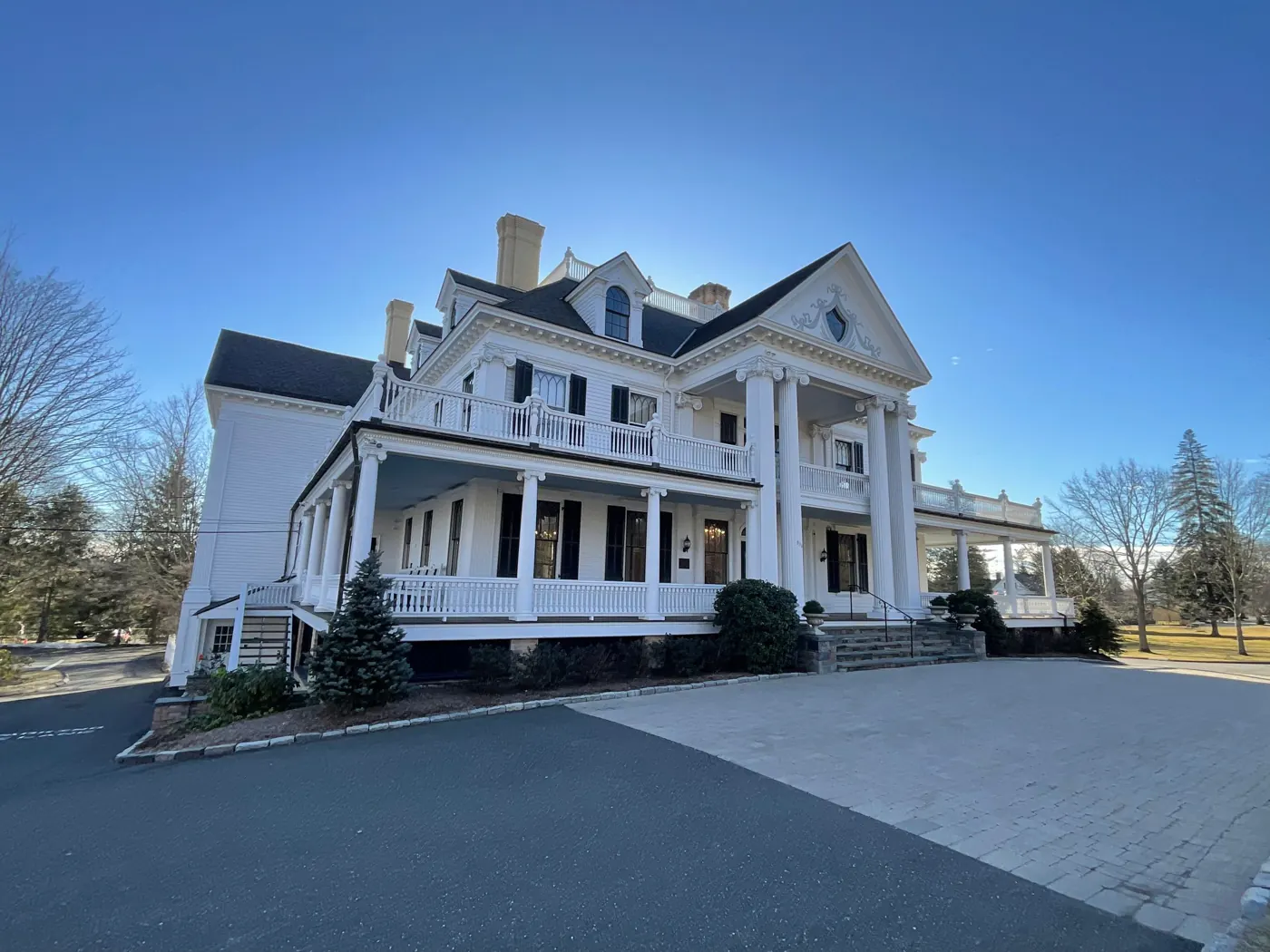 Painted white exterior of Lounsbury House in Ridgefield, CT, a Genesis Pro Painting commercial project