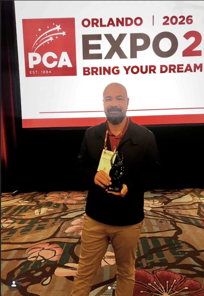 Genesis Macedo accepting an award at Orlando Expo 2026
